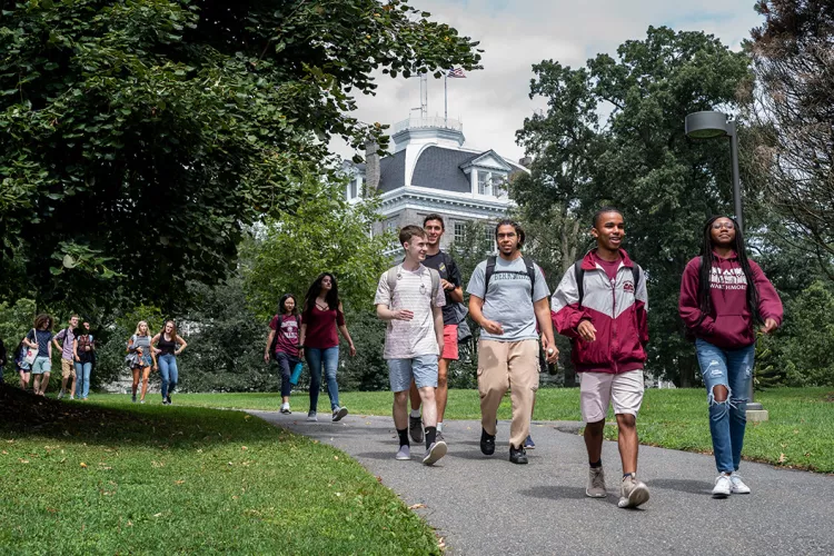 Students walk down path with Parrish in background