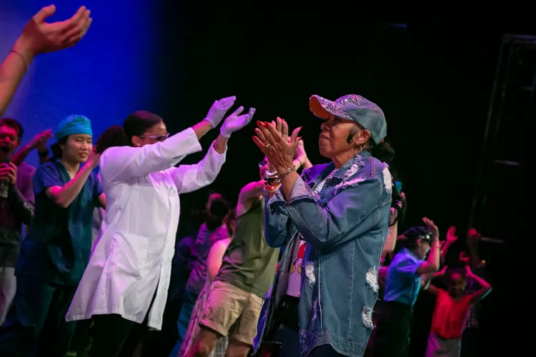 LaDeva Davis on stage with dancers during 2019 concert