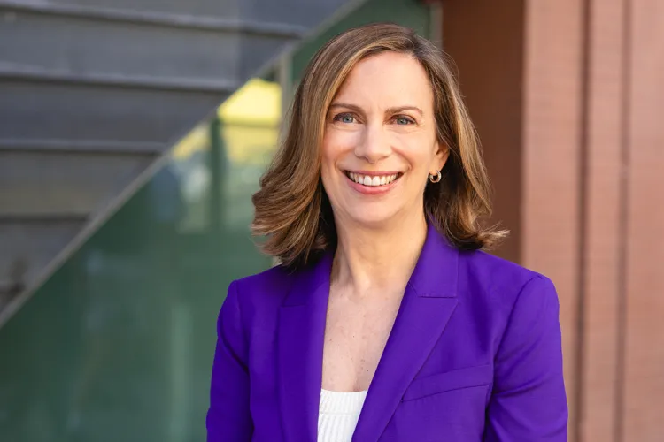 Leslie Abbey in purple suit jacket