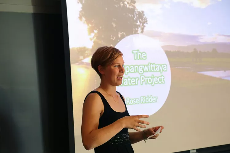 Rose Ridder '20 talks in front of projector screen