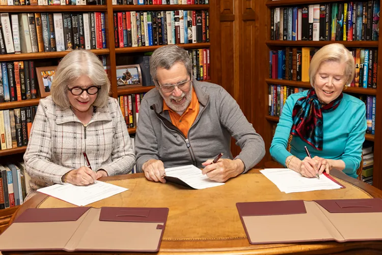 Shankers sign gift pledge at while sitting at table