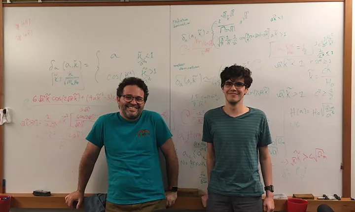 Tristan Smith and David Robinson '19 in front of whiteboard