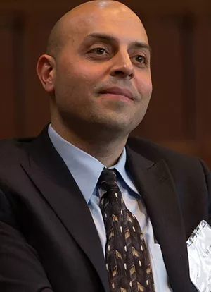 Sa'ed Atshan in suit jacket and tie, smiling