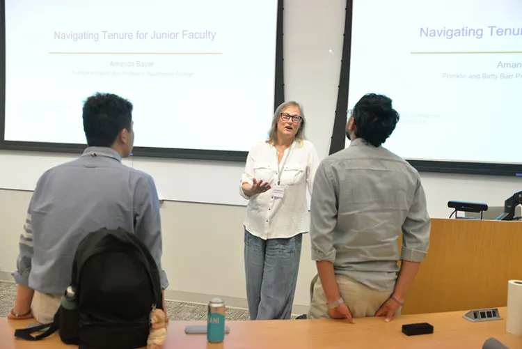 Amanda Bayer speaks to participants at macroecon conference