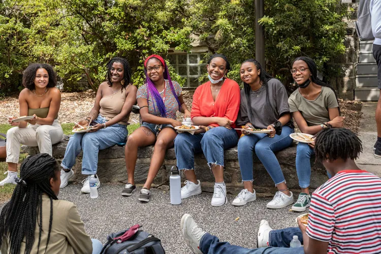 Students sit outside and eat lunch