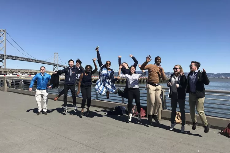 Students jump in front of bridge on CIL trip