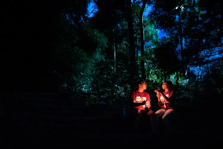 Students hold candles outdoors