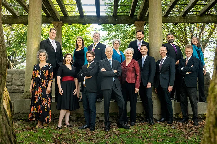 Group photo of Blue Heron musical group outdoors in nature