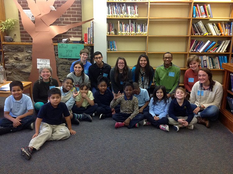 Group of adults and children in library