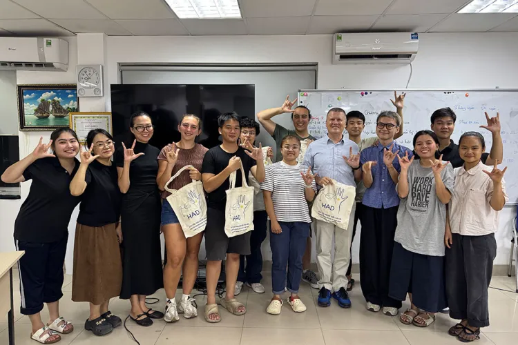K David Harrison with student researchers in classroom in Hanoi, Vietnam