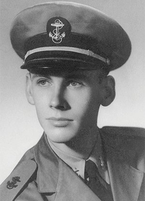 Black and white photo of man wearing military cap with anchor