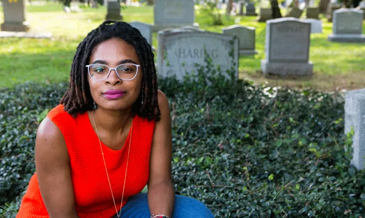 Jamie Thomas in front of tombstones