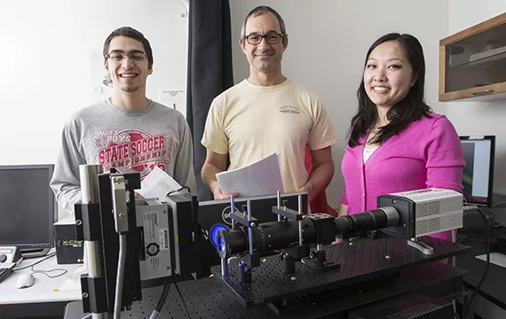 Professor Nick Kaplinsky with Erin Kast '15 and Stephanie Wey '16