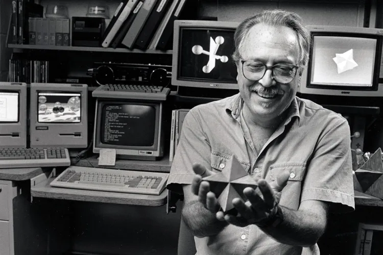 Gene Klotz holds a stella octangula featured in the Visual Geometry Project.