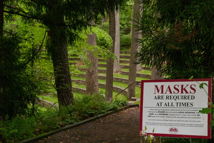 Outdoor amphitheater with sign indicating masks are required at all times