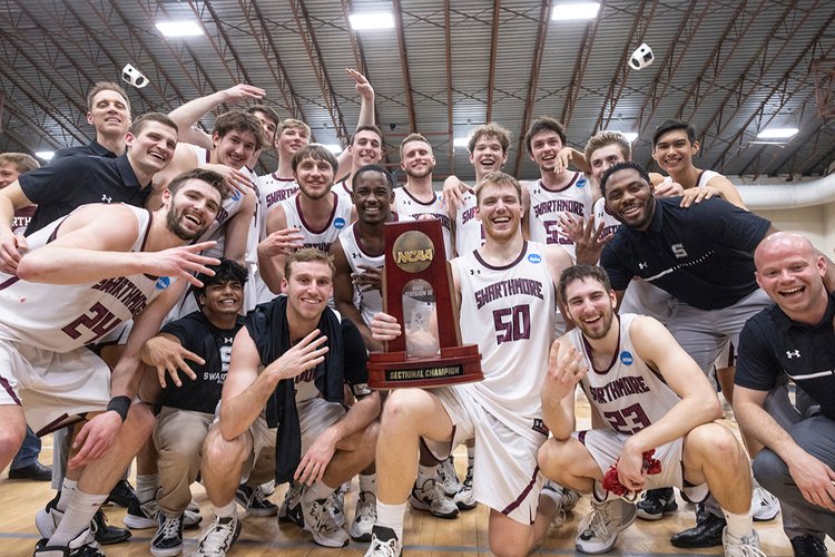 Basketball team celebrates with trophy