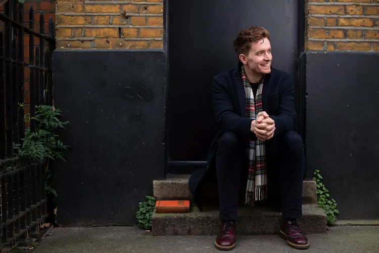 Brendan McGeever sits outside on steps