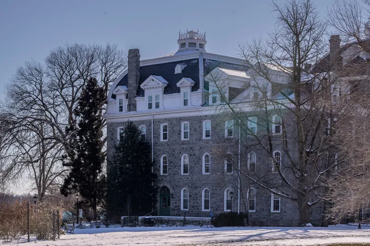 Parrish Hall stands in background with snow in foreground