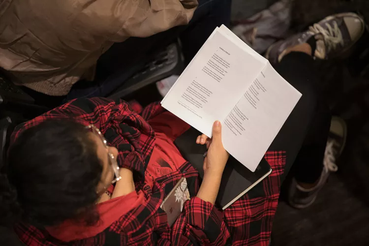 Person holds poetry reading in library