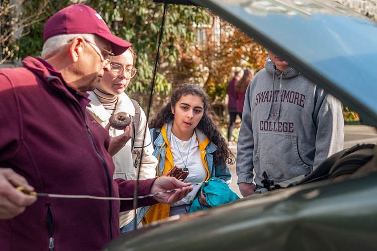 Public safety member demonstrates car maintenance