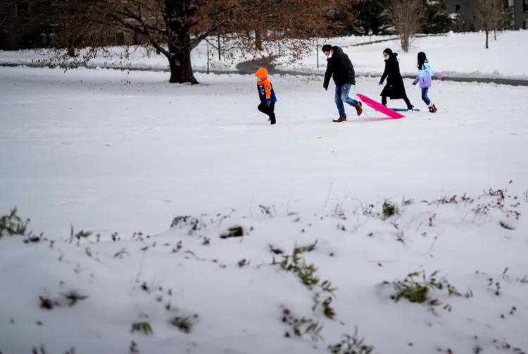 Family in snow holding sled