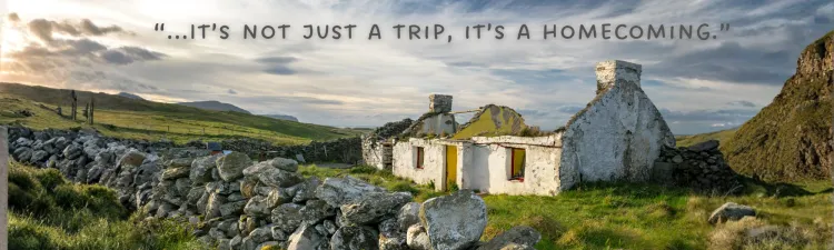 Ruins of an abandoned white cottage in a green Irish landscape
