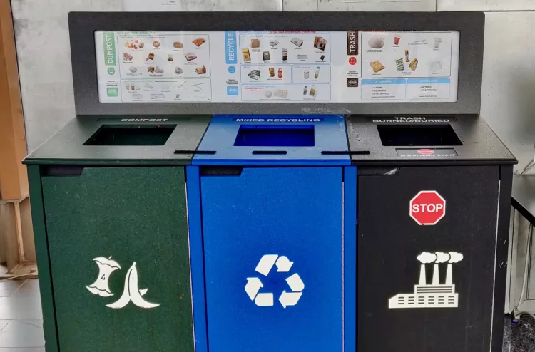 waste station with compost, trash, and recycling bins side by side