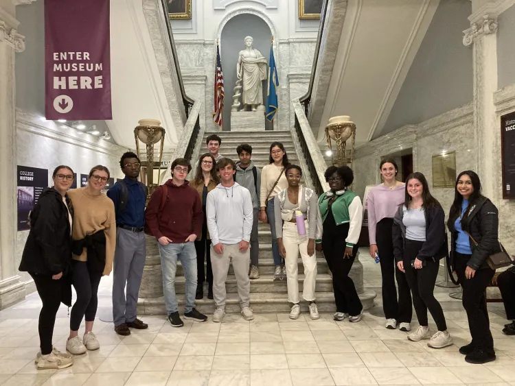 Students standing at the bottom of stairwell at the Mütter Museum.