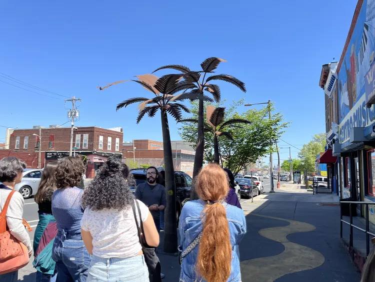 Taller Puertorriqueño - Image of Tri-Co Philly students outside of Taller Puertorriqueño, under a blue sky. Photo taken by Calista Cleary