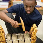 A student playing an instrument