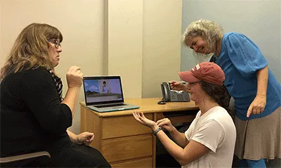 Two women communicate using sign language