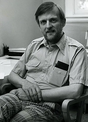 Gudmund iversen in black and white photo sitting in office chair