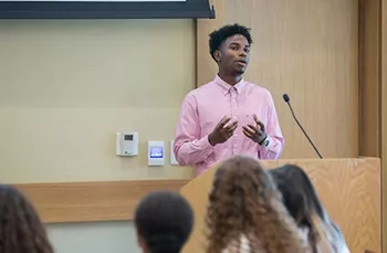 Rasheed Bryan '20 speaks at a podium