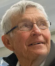 Nelson Macken aids student in engineering lab