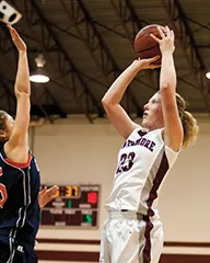 Kathryn Stockbower shoots basketball over defender