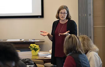 A faculty member stands in front of a class