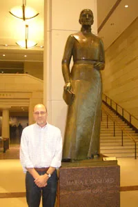 John Caskey with a statue of Maria Stanford