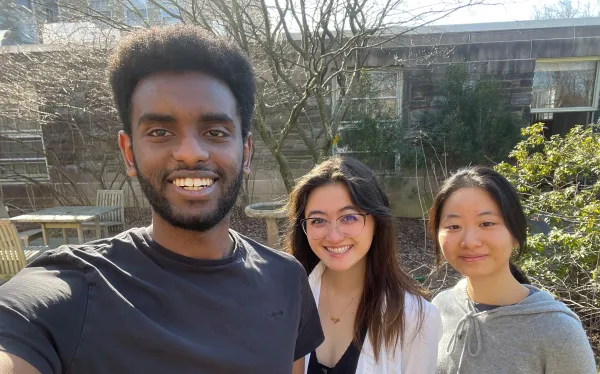 Three students pose together for a selfie