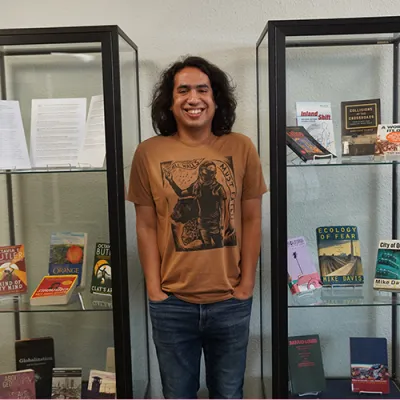 Anthony standing near an exhibition of books from his collection in McCabe Library