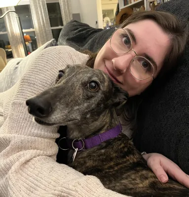 Emily cuddling with her dog, Agnes