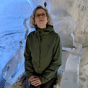 Liz Waltman seated in a chair made of ice