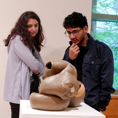 students viewing sculpture