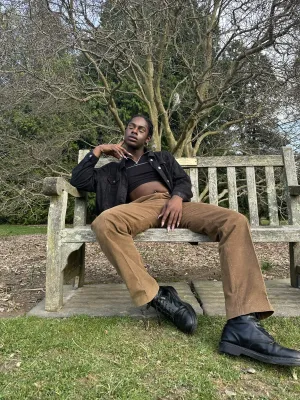 Alex Dow lounging on park bench