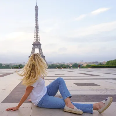 Student faces away from camera while turning toward Eiffel Tower