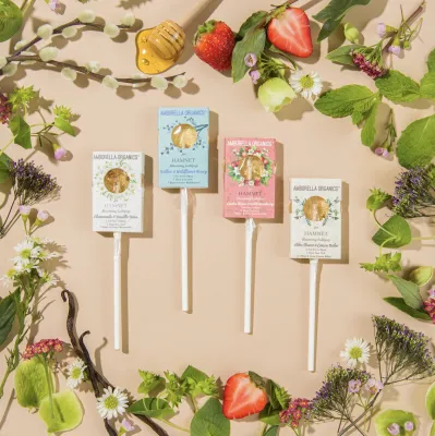 The image depicts 4 blooming lollipops surrounded by florals