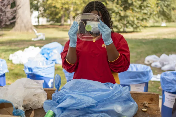 Student sorting waste at Annual Waste Characterization Study