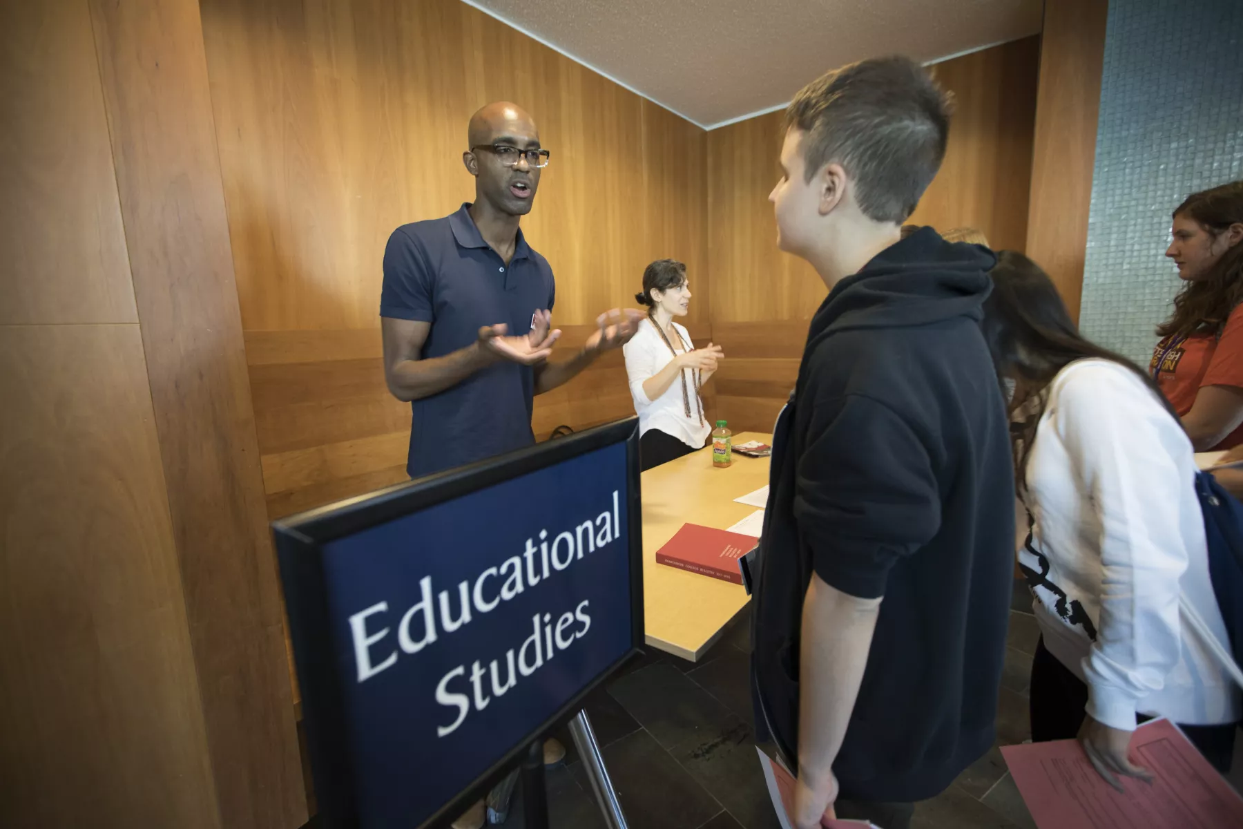professor and student talking at the new student advising fair