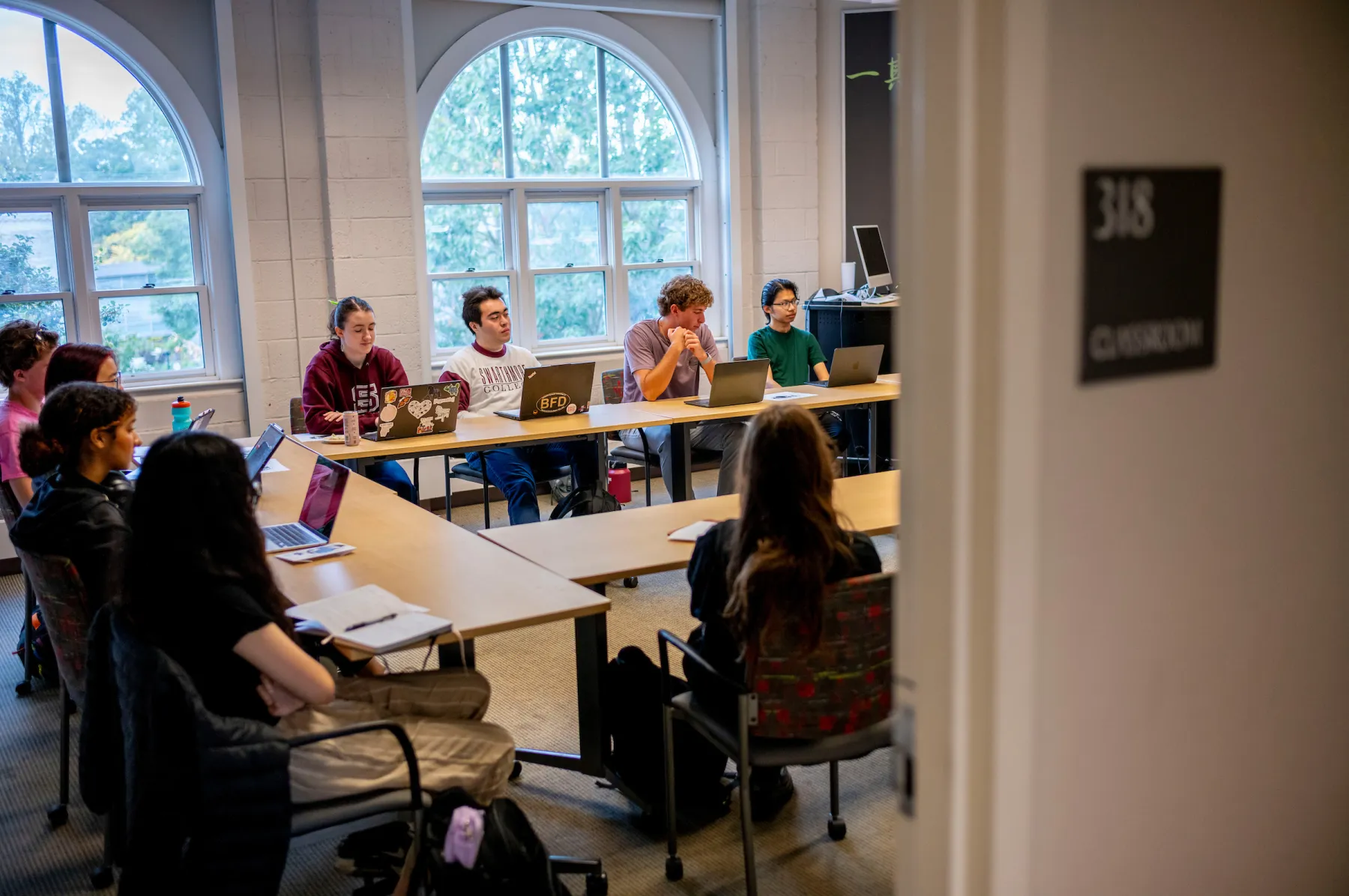 Students sit at tables in philosophy classroom