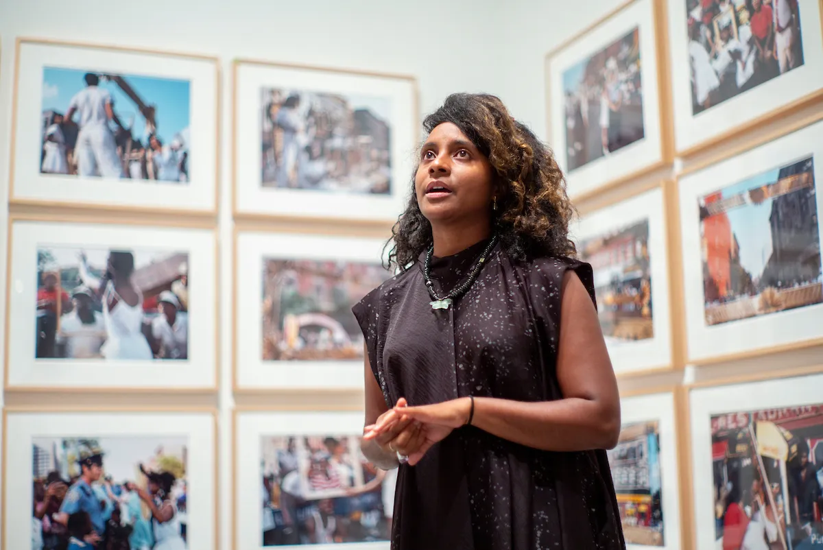 Zoe Whitley '01 speaks in front of photographs displayed at "Soul of a Nation: Art in the Age of Black Power" exhibit at the Brooklyn Museum in September 2018. 