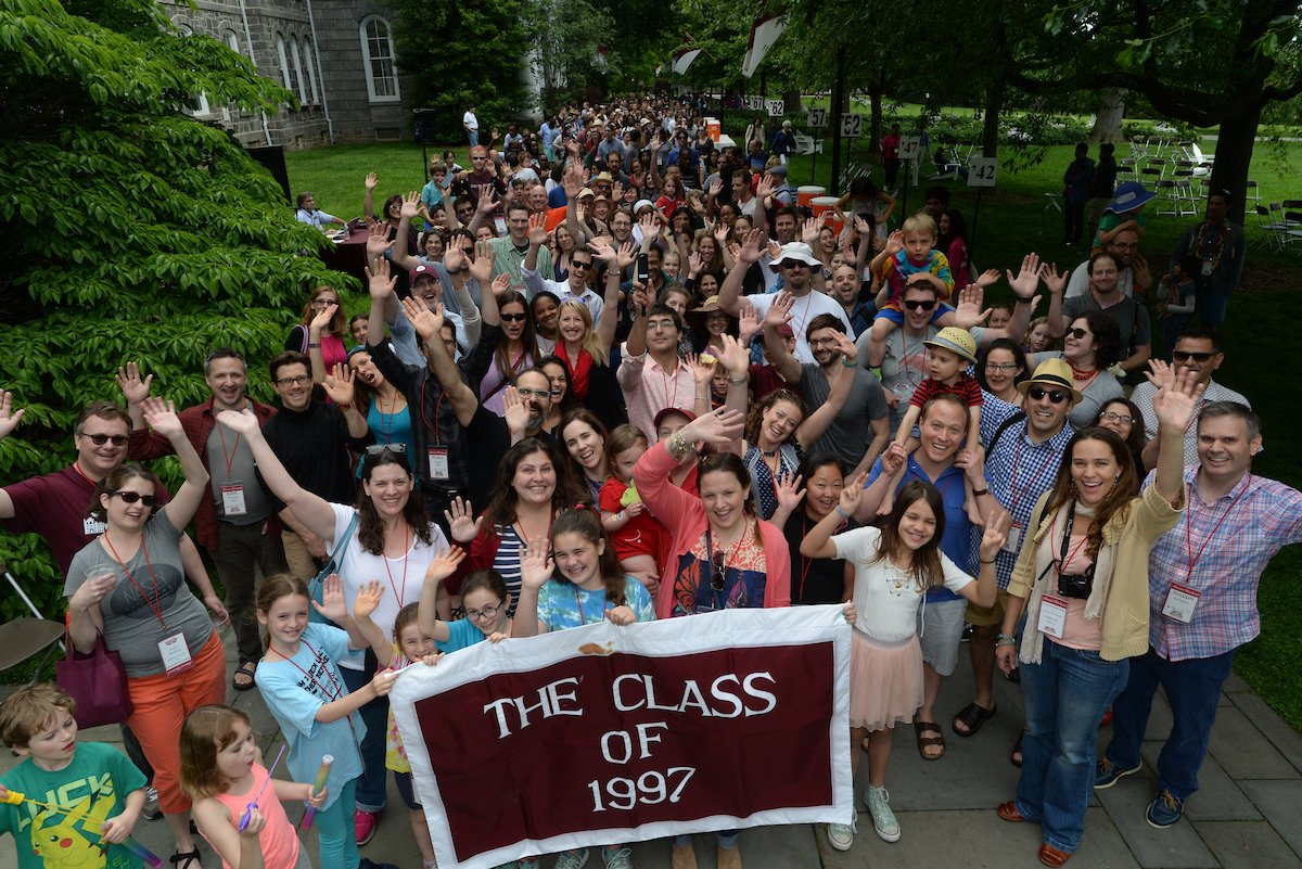 The Class of 1997 waves during the Parade of Classes
